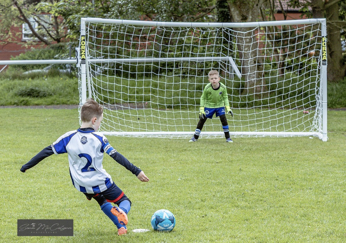 Young Culmore player taking a penalty